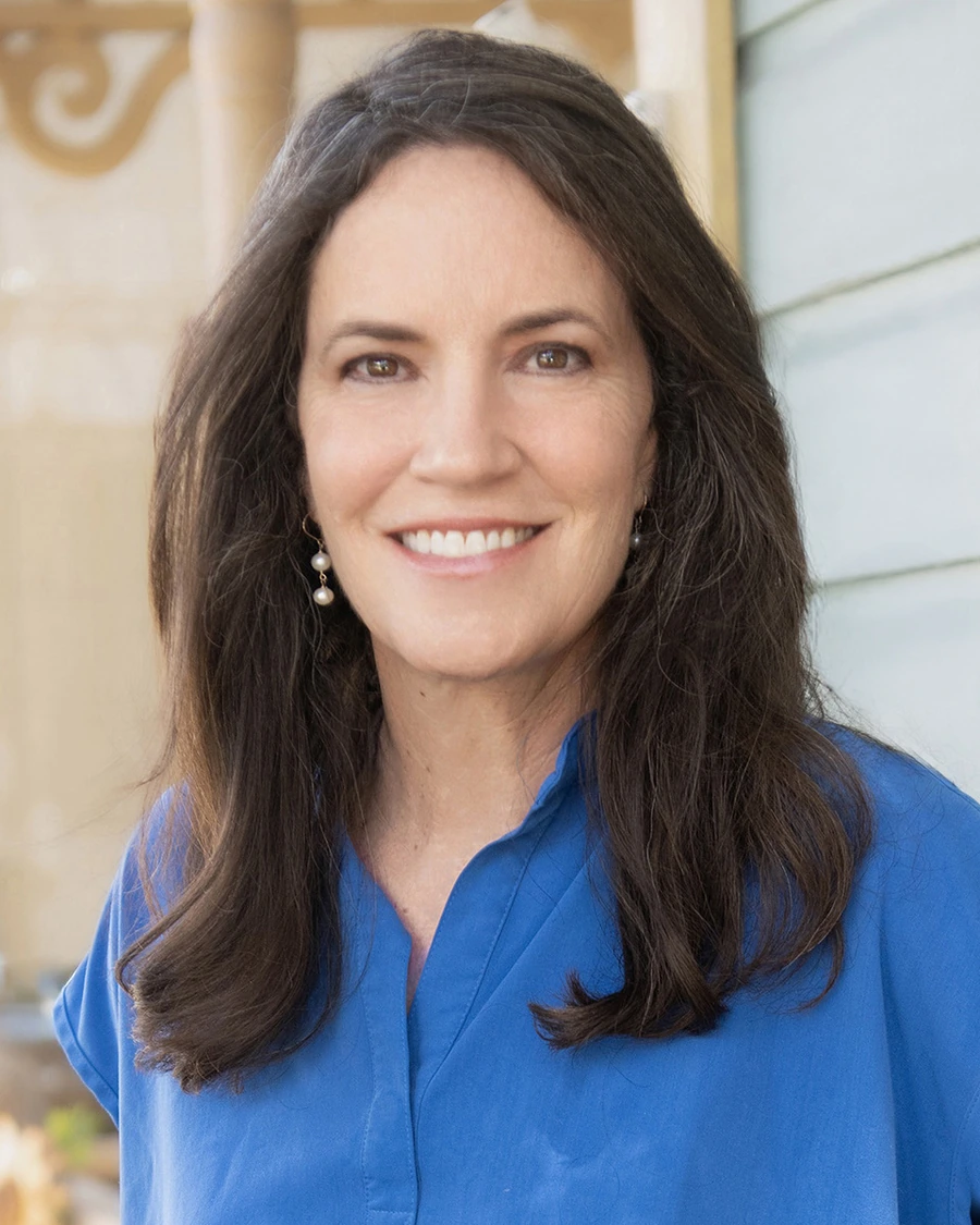 Dr. Alice Holman smiling on a porch