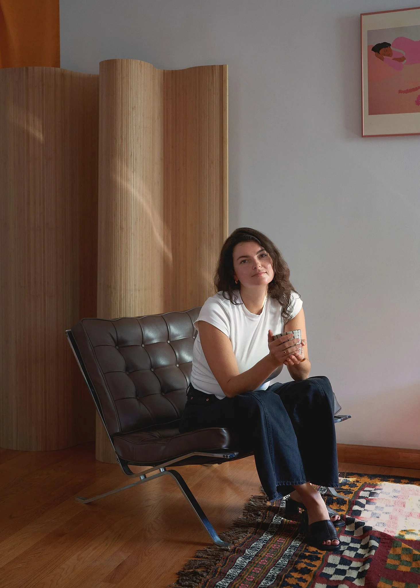 Dr. Lauren Geyman seated in a leather lounge chair, smiling