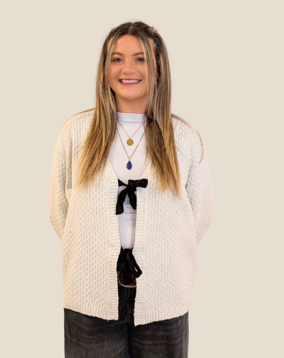 Megan Mogridge smiling in a cream cardigan